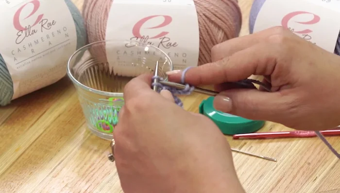 Knit across the newly cast-on stitches and the stitches of the second ear flap.