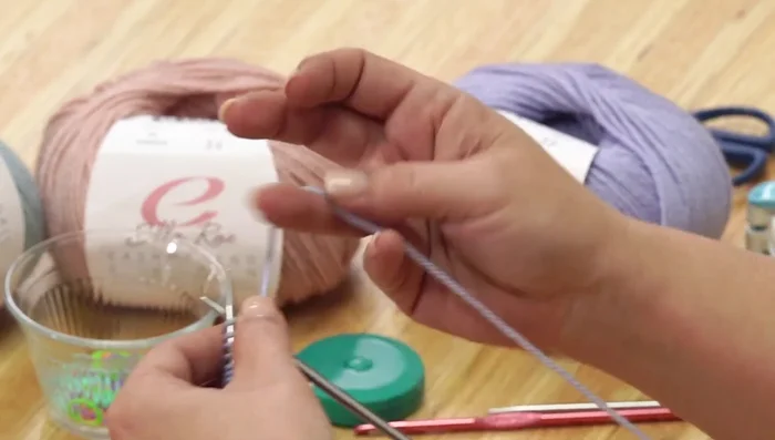 Shape the back of the hat by knitting three stitches, purling the center stitches, and knitting the remaining three stitches (for garter stitch border).