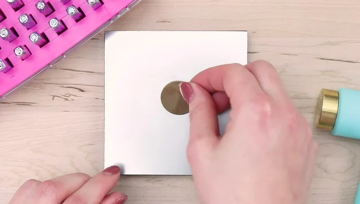 Place a large circle blank on the block. Adhere a medium circle stamp guide, securing it with tape. Write your message (e.g., child's name) on the guide.