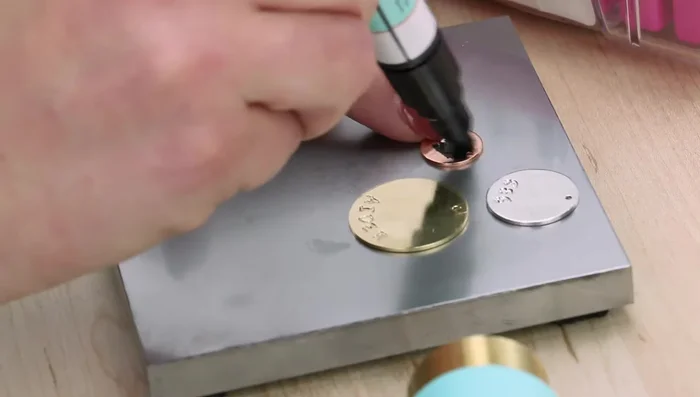 Remove the tape and guide. Highlight all three stamped impressions with enamel marker, wait three minutes to dry, then wipe off the excess enamel with a paper towel. (Rubbing alcohol can assist).