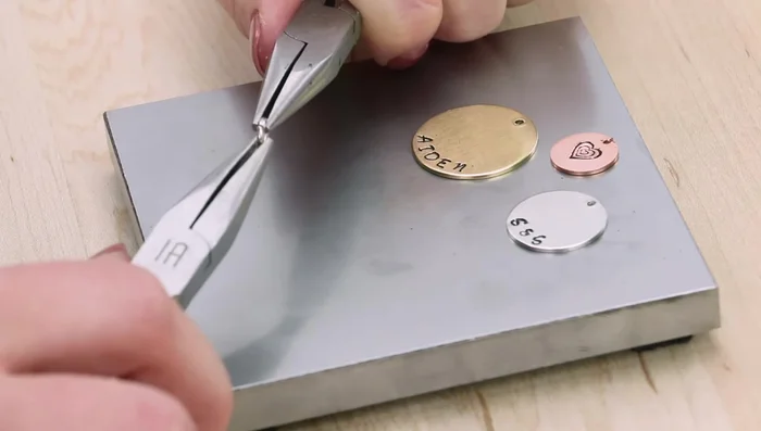 Drape the chain over the open jump ring. Close the jump ring using chain nose pliers, twisting laterally with tension until you hear a click.