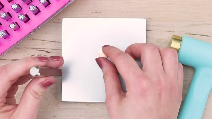 Place a 1.5-inch circle blank on your stamping block and use copper to stamp a 6mm multi-heart design using a tap and tilt technique.