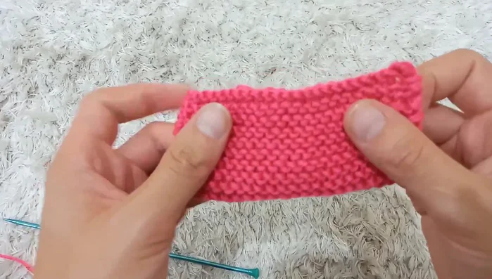 Wrap yarn around the center of the folded bow about 20 times, secure with a knot, and weave in the ends.