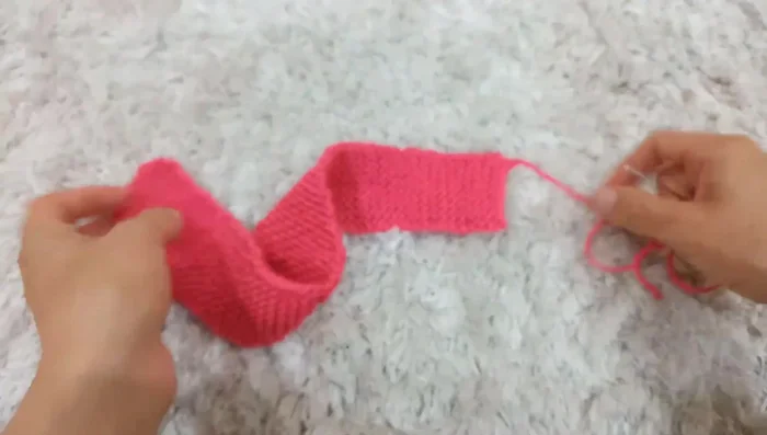 Attach the bow to the headband using a whip stitch, weaving in the ends.