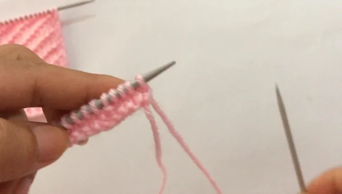 **Row 4:** Slip the first edge stitch purlwise, then repeat the pattern: purl three, knit one, purl one (until you reach the last stitch). Purl the last edge stitch.