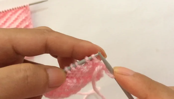 **Row 8:** Slip the first edge stitch purlwise, then repeat the pattern: purl two, knit one, purl two (until you reach the last stitch). Purl the last edge stitch.