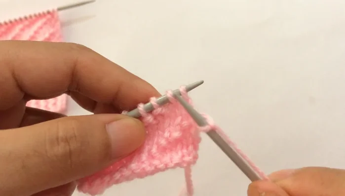 **Row 10:** Slip the first edge stitch purlwise, then repeat the pattern: purl four, knit one (until you reach the last stitch). Knit the last edge stitch.