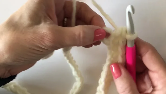 Work 13 stitches down the next side, skipping over two chain spaces.