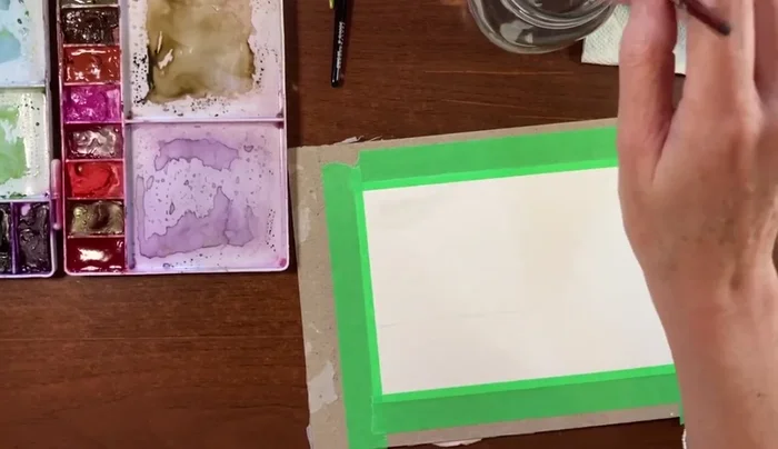 Wet the bottom two-thirds of the paper with clean water using your size 8 round brush. Tilt the board to help the water flow evenly.