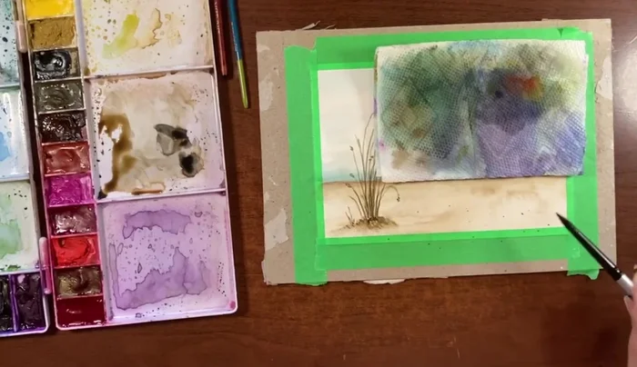 Add a few subtle flicks of a diluted sepia/burnt sienna mixture to the sand to add texture.