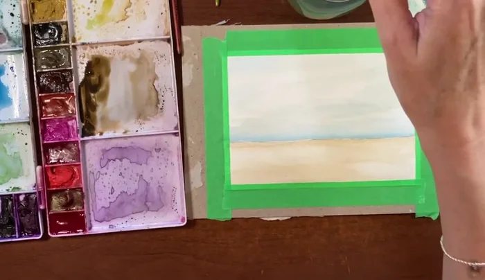 Add depth to the horizon line using a slightly darker wash of the sepia/burnt sienna mixture.