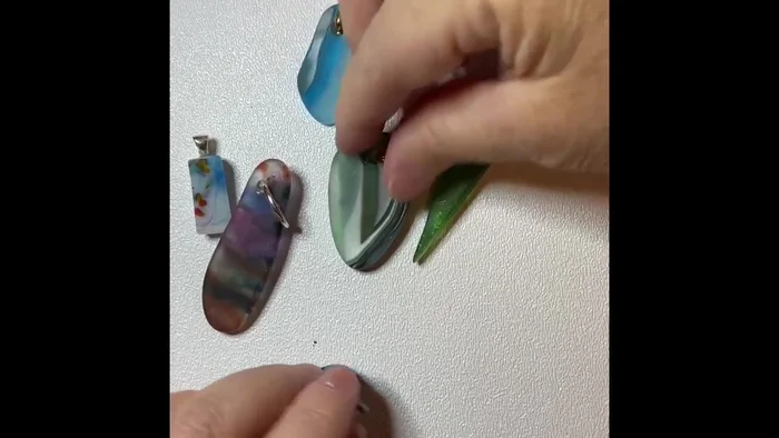 Drill holes in the tumbled pieces and add pinch bails.