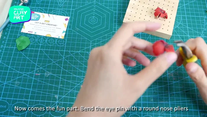 Bend the eye pin to form a loop using round nose pliers.