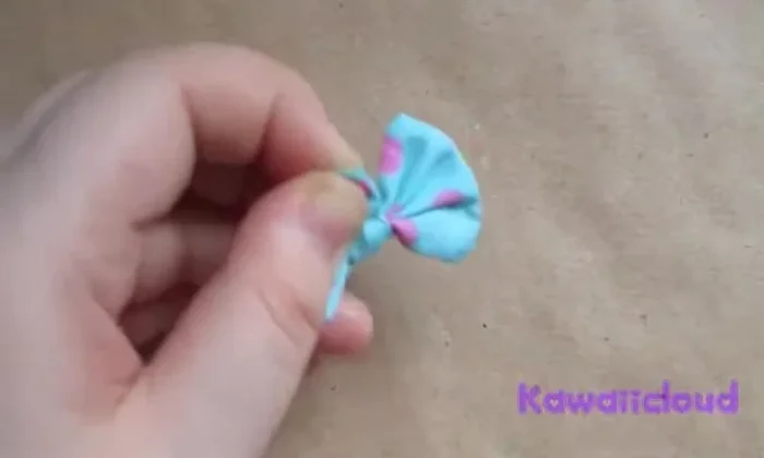 Sew the second loop securely to the first loop to create the completed bow shape.