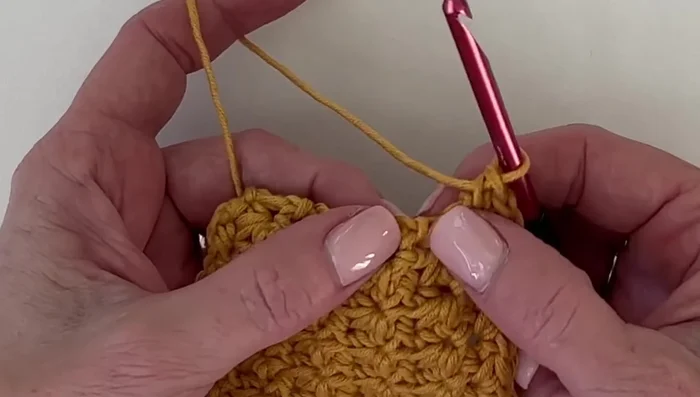 For the corners, work three single crochets into the corner stitch.