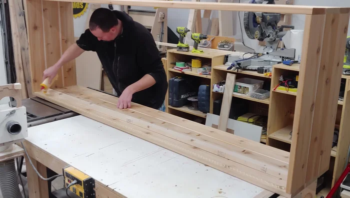 Attach the pine support to the long sides of the box using glue, 2-inch brad nails, and 2-inch construction screws.