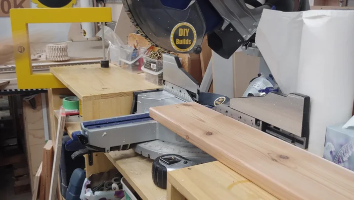 Install the bottom slats, starting with the middle one, using 3-inch screws and spacers.