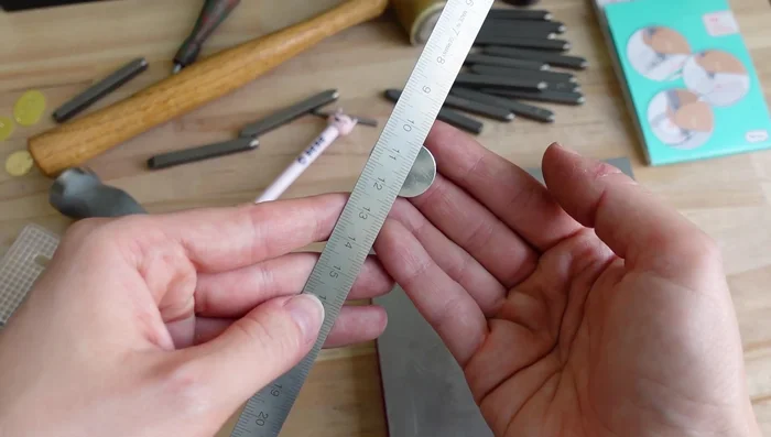 Repeat stamping process for zodiac signs, using a center finder or ruler to ensure accurate placement.