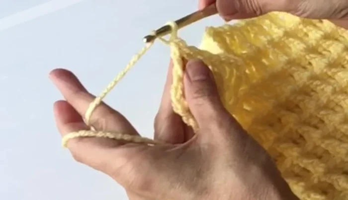 Work two rows of single crochet around the edges of the completed panel, remembering to work two single crochets in each corner to create rounded corners.