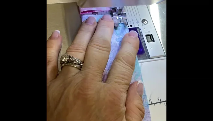 Create Pockets: Fold the four by ten and a half-inch rectangles in half (right sides together), sew with a quarter-inch seam, turn right side out, and press.