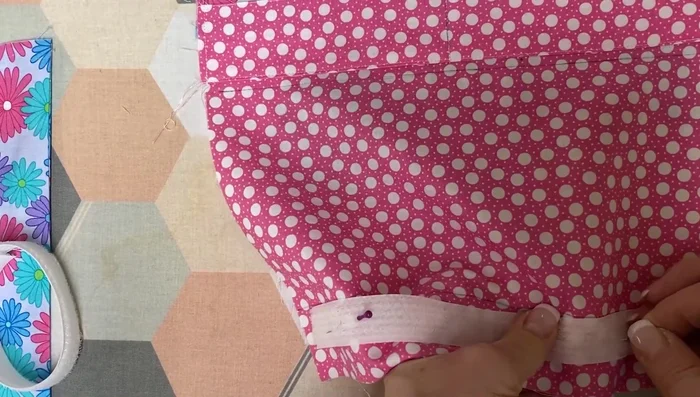 Attach Velcro: Pin and stitch a nine-inch piece of hook-and-loop Velcro centered on the top edge of the front piece.