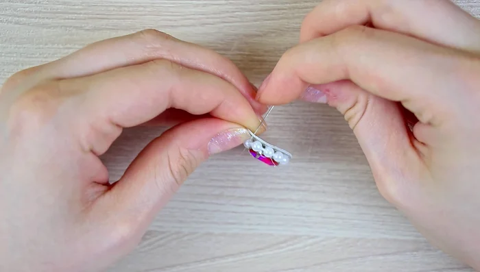 Secure all wing layers using monofilament and seed beads, creating a strong and neat connection.