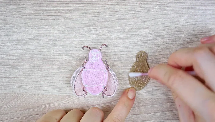 Embroider the edges of the leatherette backing with size 15 seed beads.