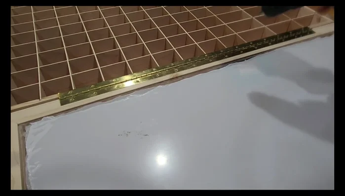 Attaching Door: Attaching cabinet door with a piano hinge.