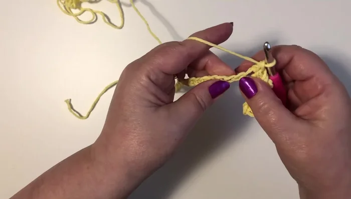 Repeat steps 3 and 4 across the row, ending with a single crochet in the last chain.