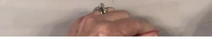 Stitch the two heart shapes together using upholstery thread and a needle, creating a surgeon's knot to secure the end.