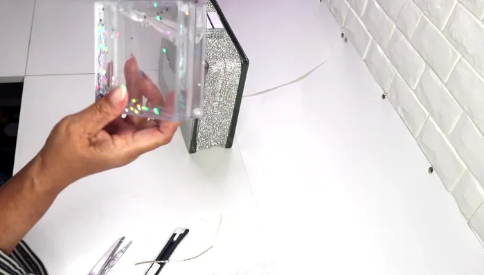 Decorate the cap (photo frame assembly) with mirror tiles, ensuring even coverage.