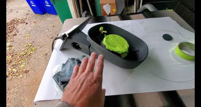 Scuff the plastic surface with red Scotch Brite to improve paint adhesion.