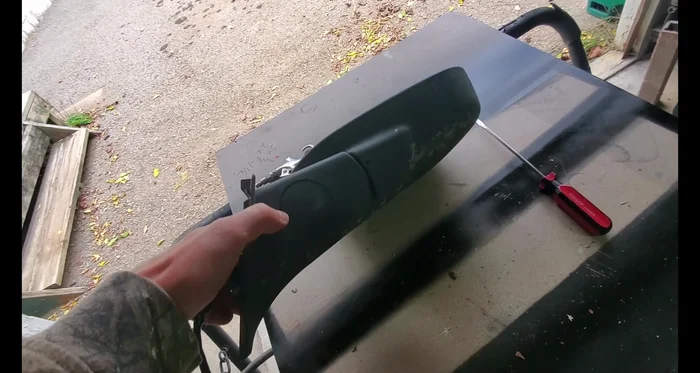 Remove the mirror assembly. It should simply pop off using a screwdriver.