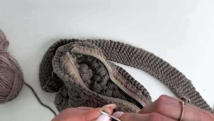 Optionally, sew down the loose ends of the crocheted zipper to keep them neat and tidy.
