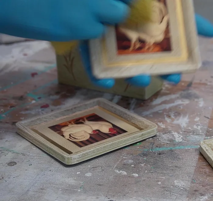 Address any issues: If necessary, remove any glued-on images (like the rooster in this example) before re-priming.