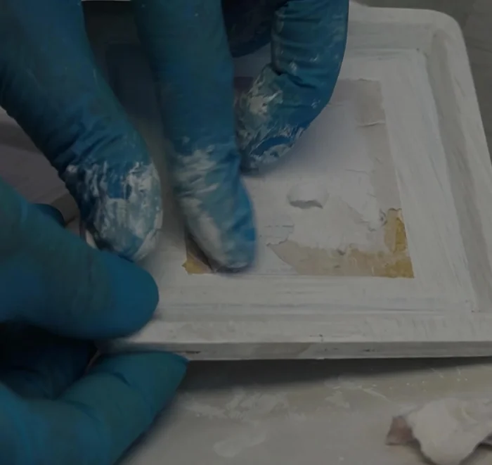 Address any issues: If necessary, remove any glued-on images (like the rooster in this example) before re-priming.