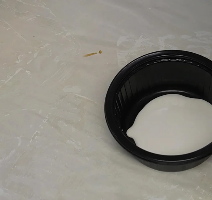 Layer and pour paints: Layer your chosen paints (start with a base color, then add accent colors) in a container, and pour the mixture onto the coaster, tilting and moving the coaster to spread the paint.