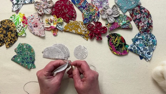 Gather petals: Pull the thread gently to gather the petals, forming a flower shape.