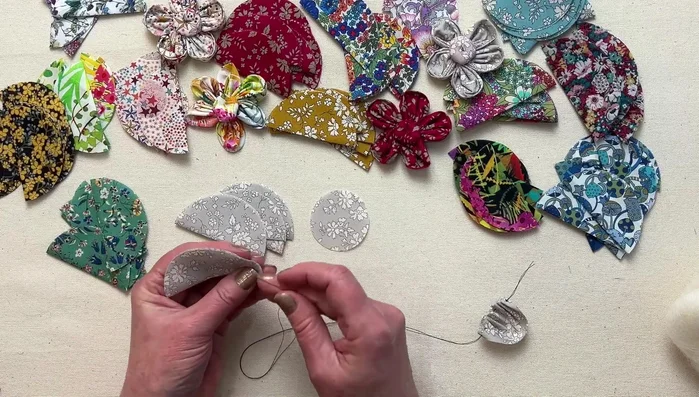 Gather petals: Pull the thread gently to gather the petals, forming a flower shape.