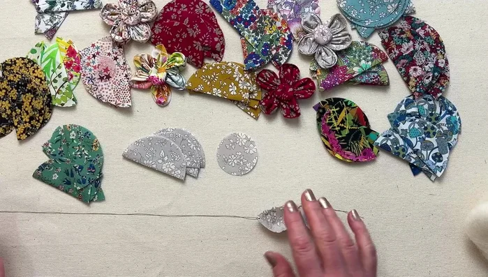 Gather petals: Pull the thread gently to gather the petals, forming a flower shape.