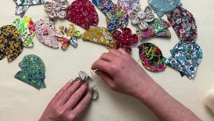 Secure the flower: Bring the thread to the back and tie off with a knot. Add a couple of stitches on the back for extra security (optional).