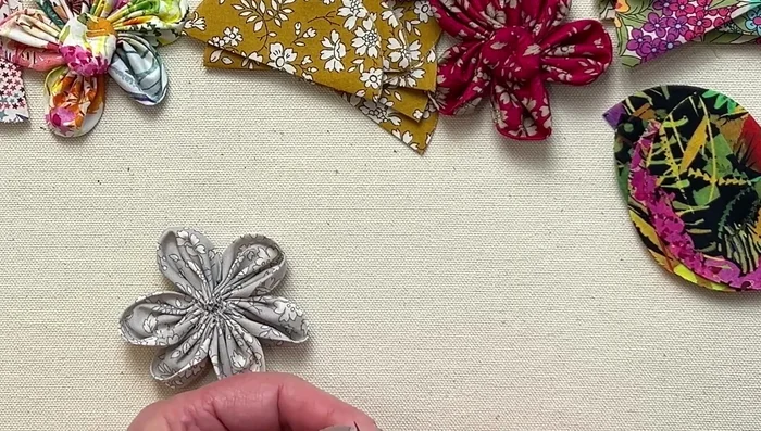 Create a button center (optional): If desired, create a small button center by running your needle around a small circle and filling with wool or cotton.