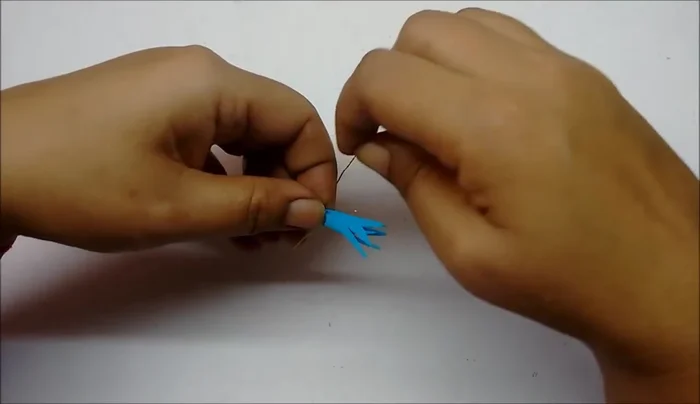 Wrap floral tape around the base of the floret to secure the wire. Curl the petals outwards using scissors.