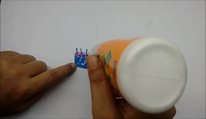 Attach the prepared stamen strip to a thick wire to create the center of the flower.