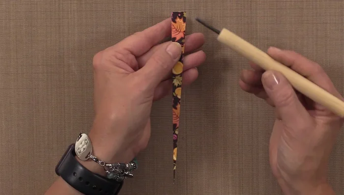 Remove the finished paper bead from the tool and let it dry completely on a drying rack.