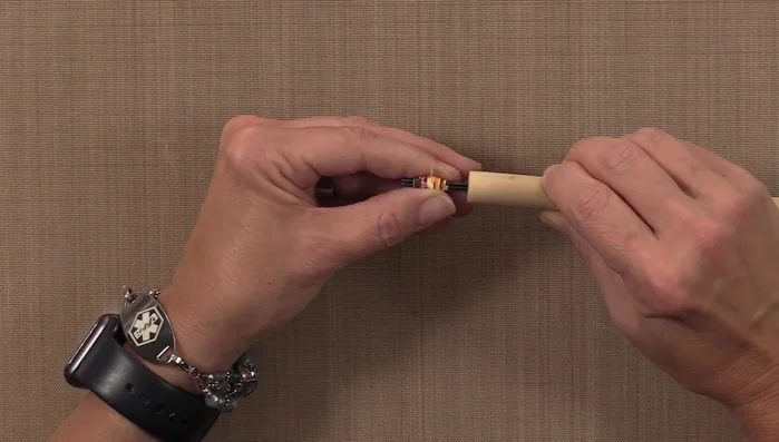 Remove the finished paper bead from the tool and let it dry completely on a drying rack.