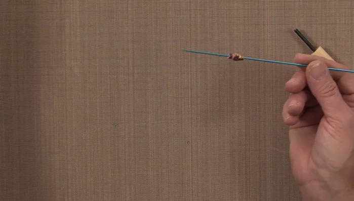 Remove the finished paper bead from the tool and let it dry completely on a drying rack.