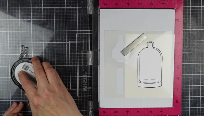 Position the negative mask of the floral stencil over the stamped vase, securing it with the Misti. Stamp the floral image using permanent black ink to prevent ink smearing.