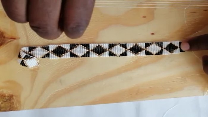 Lock the beads in place and continue. The first step is challenging; ensure no beads share a space.