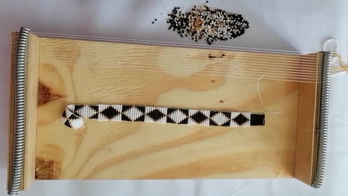 Lock the beads in place and continue. The first step is challenging; ensure no beads share a space.